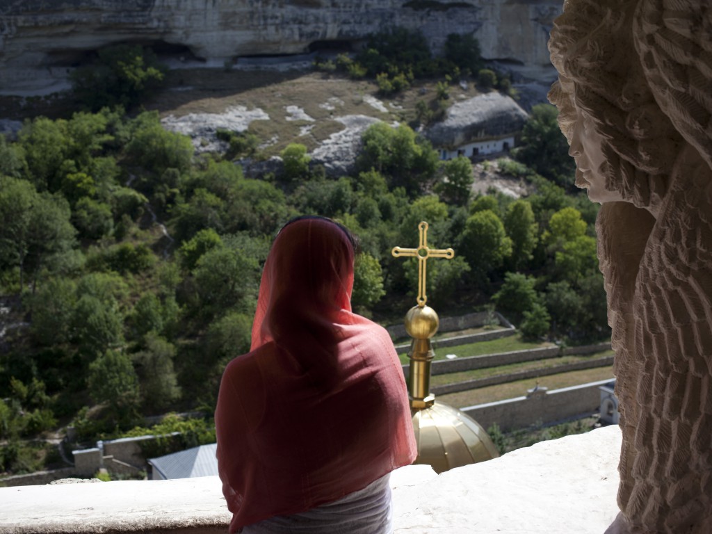 A woman in Uspensky Cave Monastery in Bakhchisaray. Crimea. 03.08.14